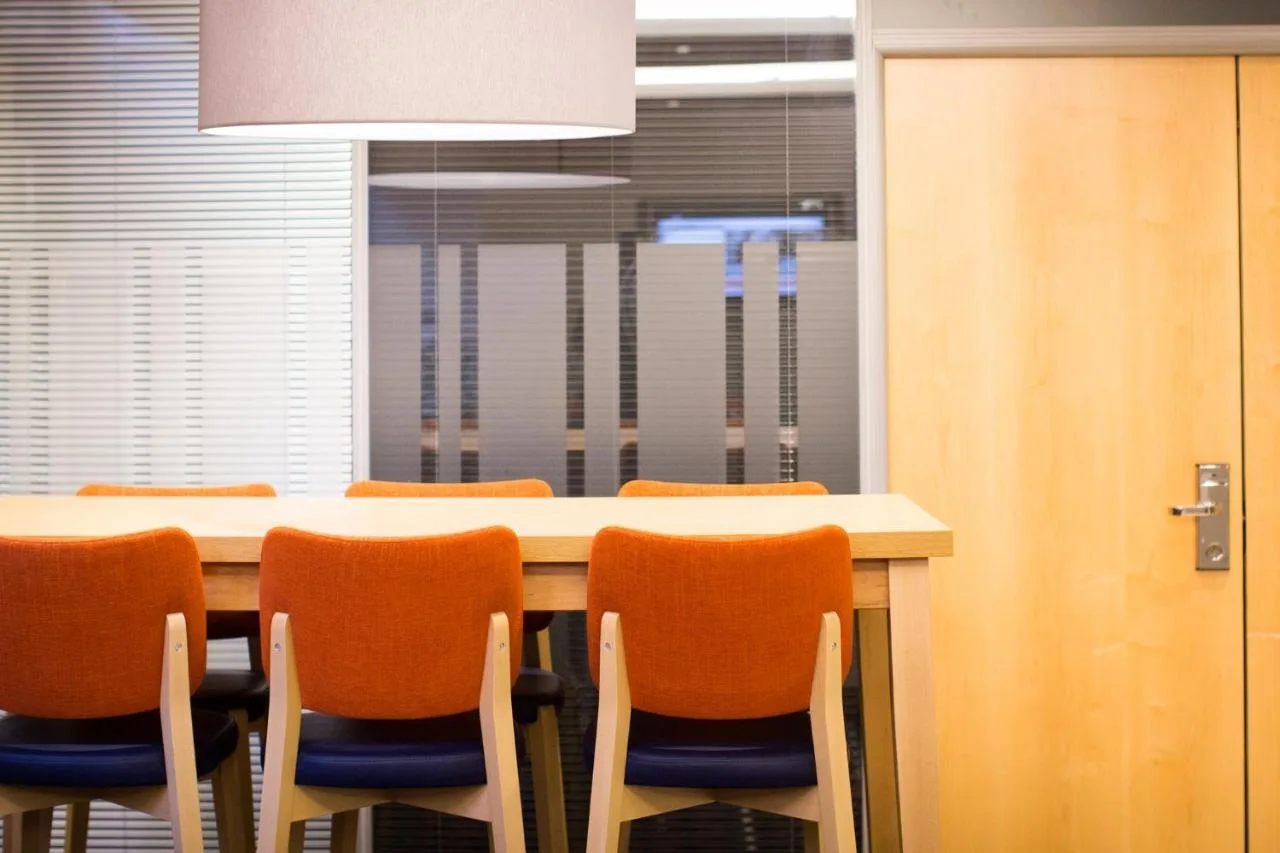 Conference room with table and orange chairs at Holiday Inn Express Edinburgh – Royal Mile